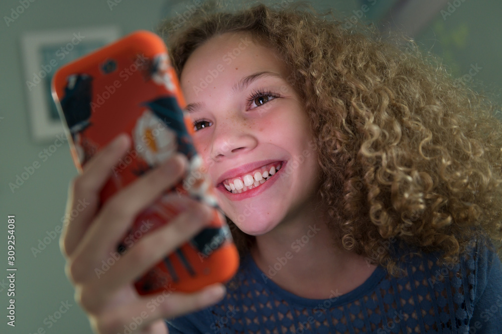 Girl smiling using smartphone Girl smiling using smartphone