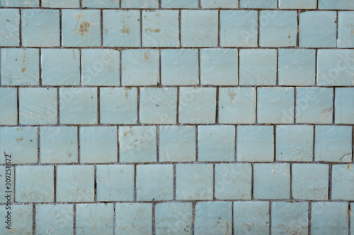 Blue tiles on a wall as a background image.