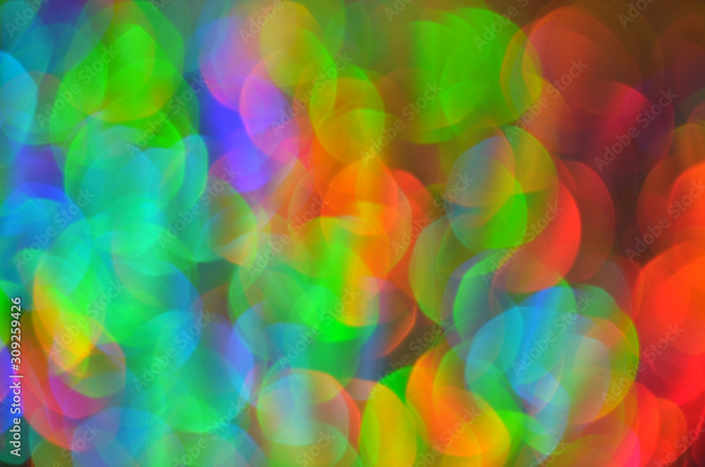 Shiny abstract background with festive defocused lights, colorful bokeh. Christmas or New Year holiday concept.