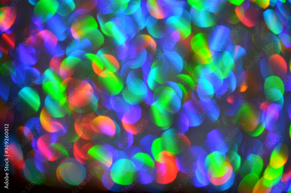 Shiny abstract background with festive defocused lights, multicolor bokeh. Christmas or New Year holiday concept.