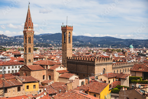 Beautiful super wide-angle aerial view of Florence, Italy with Florence Cathedral di Santa Maria del Fiore, mountains, skyline and scenery beyond the city, seen from the tower of Palazzo Vecchio