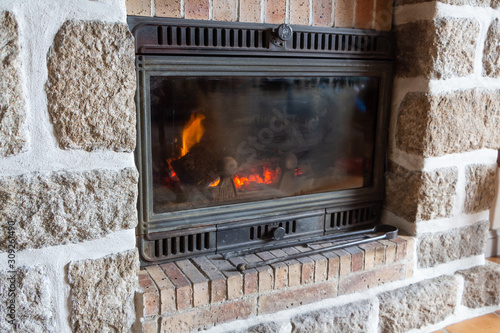 Fireplace insert with a fire in a living room