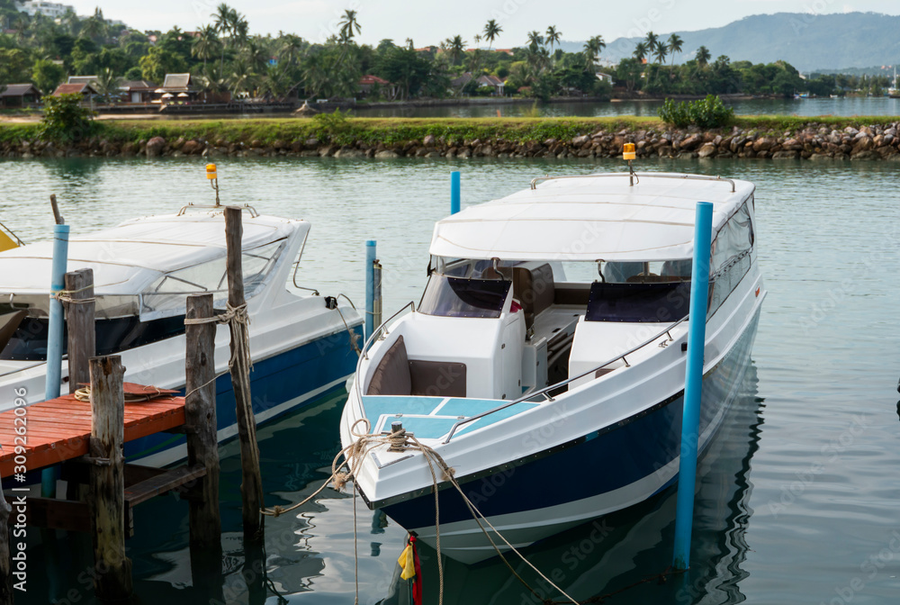 Beautiful white modern yachts at sea port in Asia.