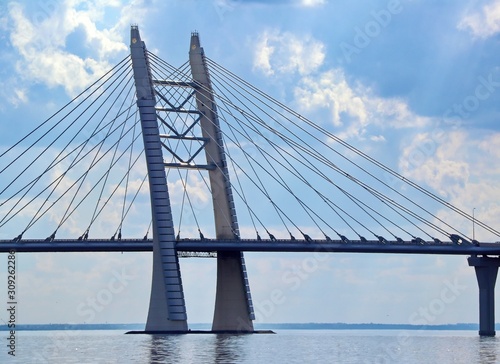 prop of the cable bridge across the river against the background of clouds