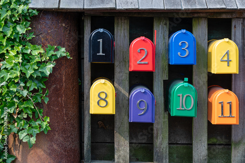 A row of colourful numbered postal boxes