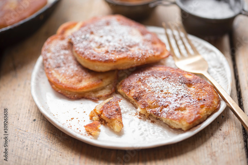 Pancakes with apples, cinnamon and icing sugar 