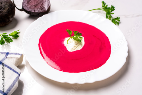 creamy beet soup on white table