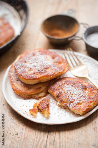 Pancakes with apples, cinnamon and icing sugar 