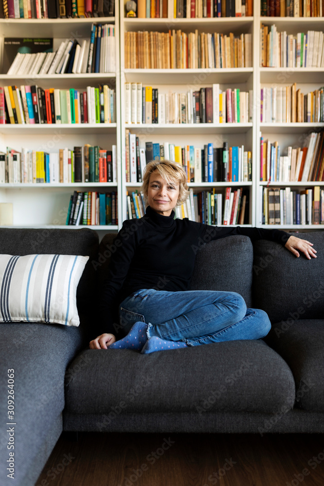 Portrait of mature woman relaxing on couch at home Portrait of mature woman relaxing on couch at home