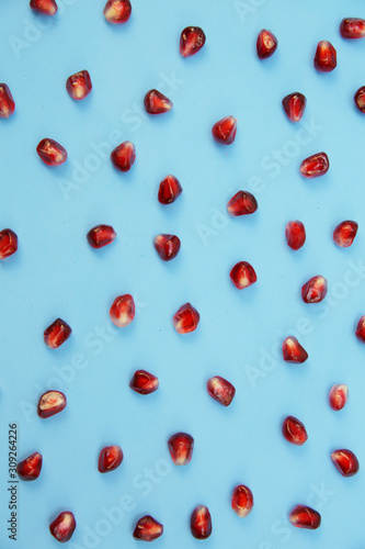 pomegranate seeds isolated on background. Healthy fruits, vegan food, diet. Flat lay. Top view. Vertical photo.