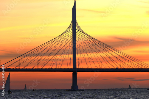 observation deck on the shore with a view of the cable-stayed bridge and sunset