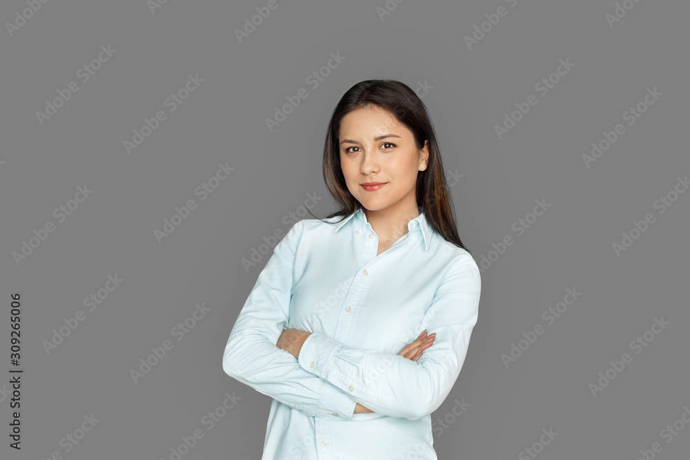 Freestyle. Young woman standing isolated on grey crossed arms smiling confident Freestyle. Young woman standing isolated on grey crossed arms smiling confident