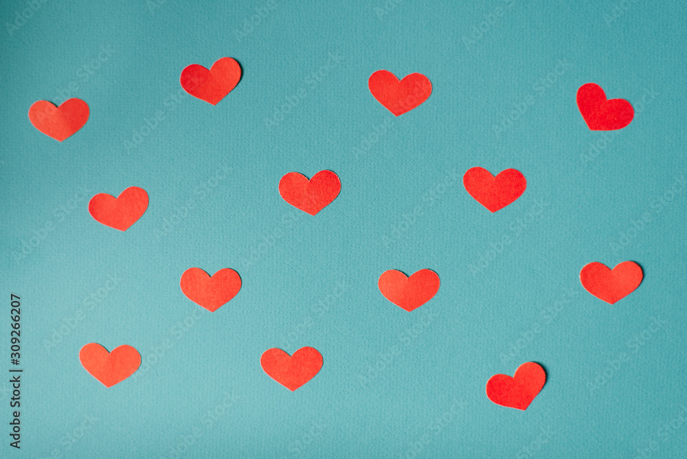 Romantic Valentine's day background, cute hearts flat lay, minimalist banner Wallpaper design. Red paper cut hearts on blue background