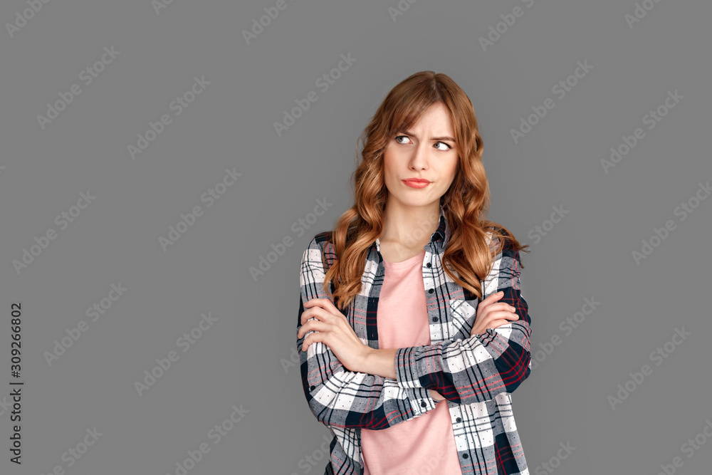 Copy Space for Text or Product . Stylish woman studio standing isolated on grey looking aside concerned Copy Space for Text or Product . Stylish woman studio standing isolated on grey looking aside concerned