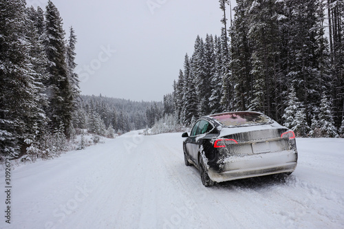 Electric car driving, mountains snow