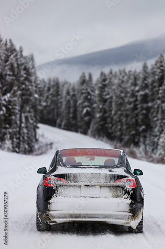 Electric car driving, mountains snow