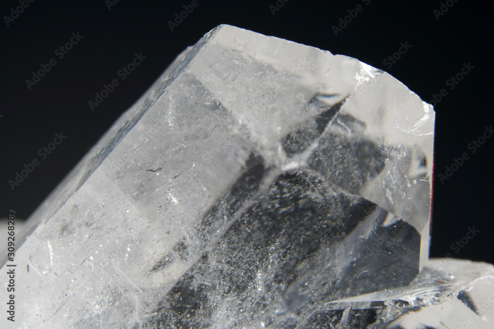 Quartz also called deep quartz with mineral inclusions in the studio in front of black background photographed in Marco mode 