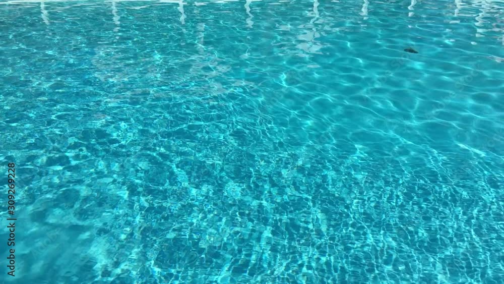 Swimming pool water in a luxury resort on a sunny summer day. Swimming pool water in a luxury resort on a sunny summer day.