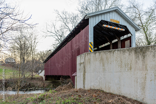Baumgardner's Mill Covered Bridge Spanning Pequea Creek in Lancaster County, Pennsylvania photo