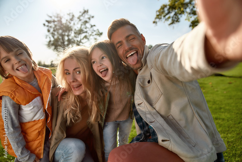 Proud to have a family. Happy family taking selfies outdoors