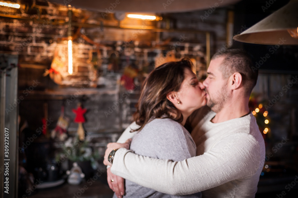 Portrait of a young couple in the living room at Christmas. Portrait of a young couple in the living room at Christmas.