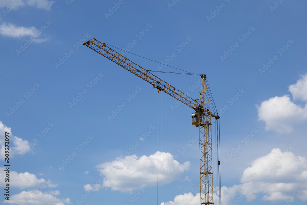 Industrial construction building crane and big clouds