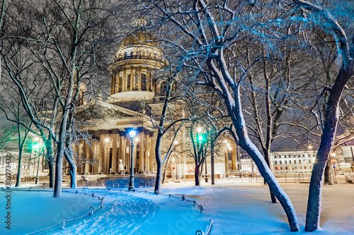 Saint-Petersburg. Russia. St. Isaac's Cathedral in the winter evening. Snow-covered trees on the background of St. Isaac's Cathedral. Winter Petersburg. Architecture Of St. Petersburg.
