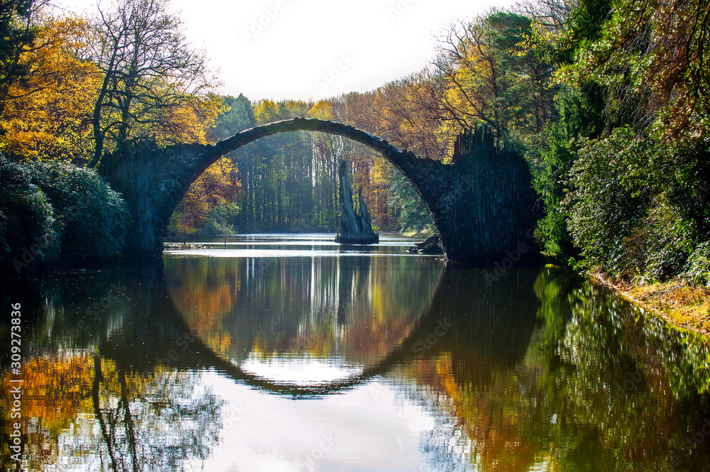 Autumn park Kromlau. Rakotz Bridge, Rakotzbrucke Devil's Bridge