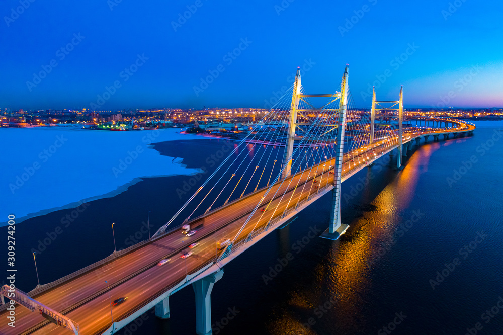 Saint Petersburg. Russia at night. A bridge over a frozen bay. Bypass bridge in St. Petersburg. Shore of the Gulf of Finland at night. Ice Russia in the winter. Snow Russian roads. Trip to Russia