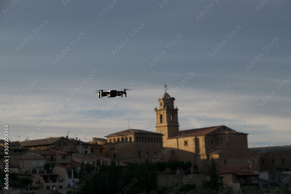 A DRONE FLYING OVER A TOWN