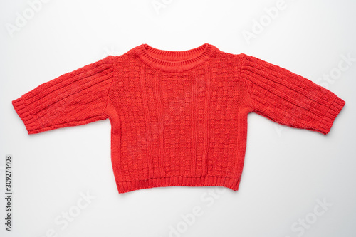 Kids knitted sweater with pattern. Beautiful red woolen autumn sweater with long sleeves. Front view. On white background