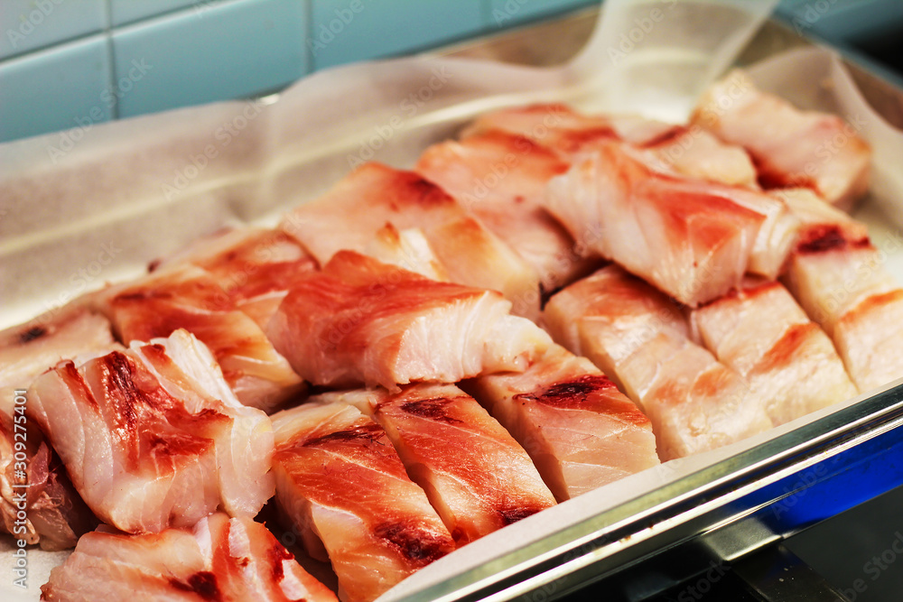 slices of raw fish ready to be prepared in a professional kitchen