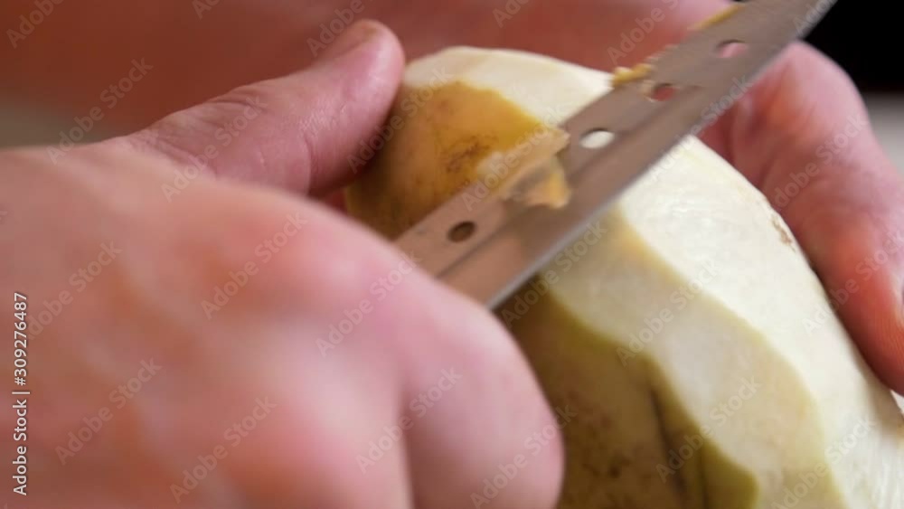 Man peeling half of turnip Man peeling half of turnip