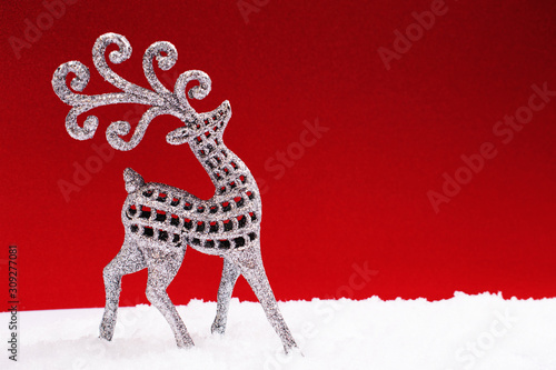 Fototapeta Naklejka Na Ścianę i Meble -  Silver glitter Christmas deer on red background.