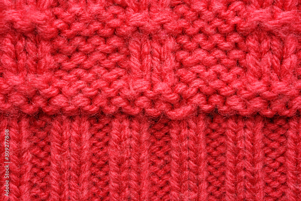 The texture of a knitted sweater. Red pattern. Facial surface. Background. Copy space The texture of a knitted sweater. Red pattern. Facial surface. Background. Copy space