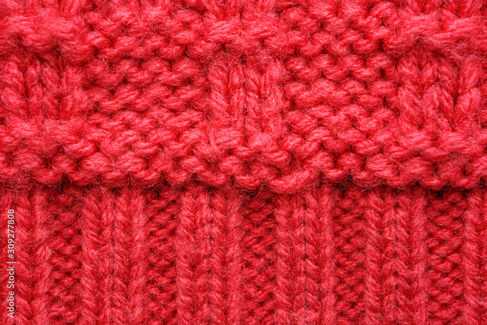 The texture of a knitted sweater. Red pattern. Facial surface. Background. Copy space