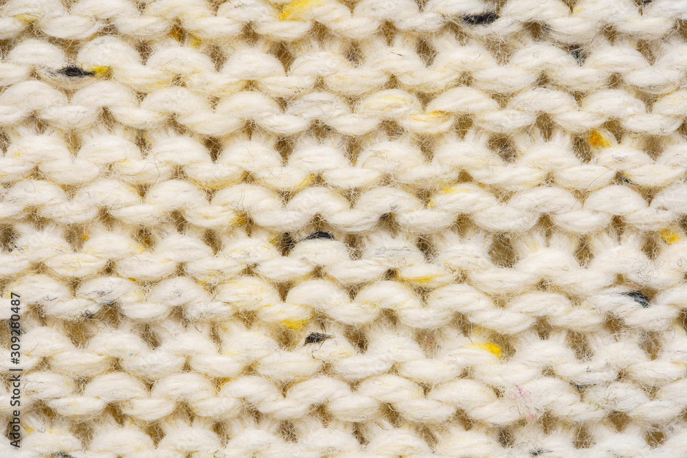 The texture of a knitted sweater. Beige pattern. Inside. Background. Copy space The texture of a knitted sweater. Beige pattern. Inside. Background. Copy space