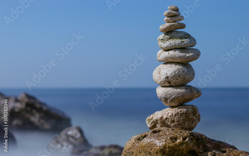 Object of stones on the background of the night sky and the  sea. Zen stones. Harmony   Meditation