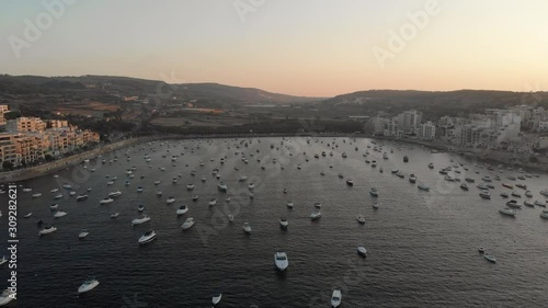 Aerial drone video from Malta, St Pauls' Bay and Xemxija area. The bay and surroundings with many anchored boats in the bay. MMXIX.VII.I photo