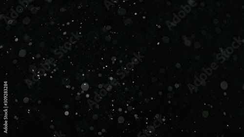 Natural organic dust particles on black background. Glittering Particles With Bokeh. Slow motion at 1000 fps. photo