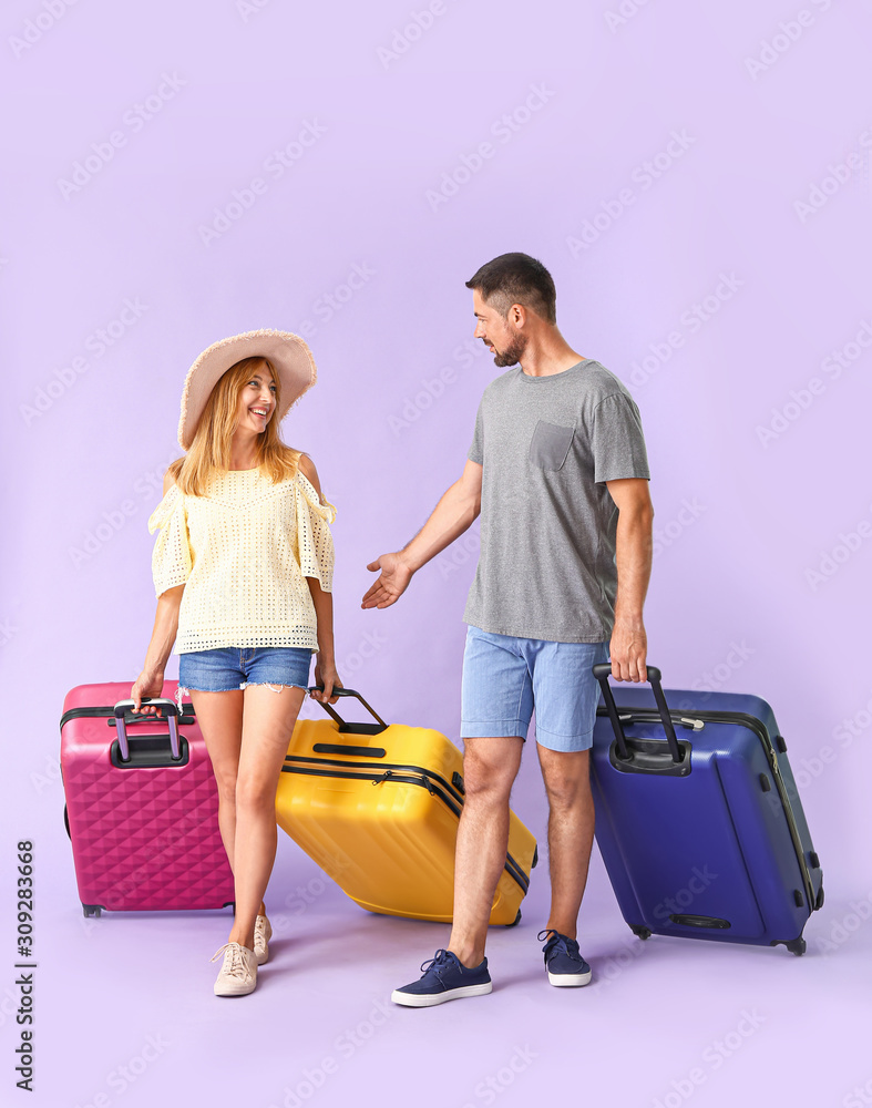 Couple with suitcases on color background Couple with suitcases on color background
