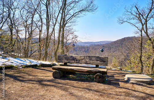 Bench on the witch dance place in Thale with cable car in the background. Saxony-Anhalt, Harz, Germany photo