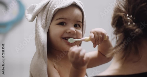 Portrait of cute toddler girl doing her after bath routine. Shot in 4K RAW on a cinema camera.