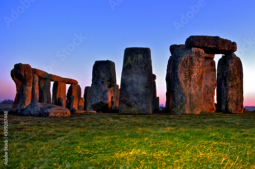 Prehistoric Stonehenge at sunset with strobe illuminating foreground to add depth, Wiltshire, England  photo