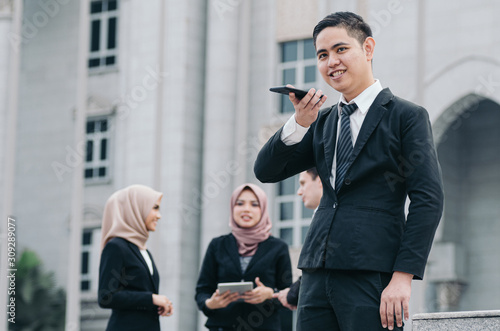Portrait of young businessman talking to Someone on his Mobile Phone with Happy Facial Expression.