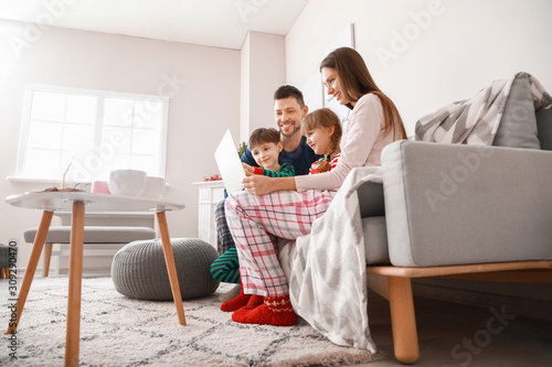 Happy family with laptop re...