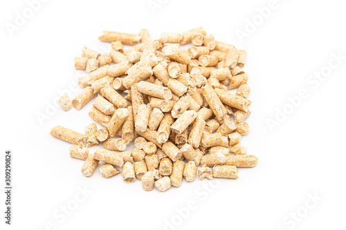 Close up compressed wood pellets for use as an eco-friendly renewable organic biofuel over a white background. Eco-friendly renewable fuel concept