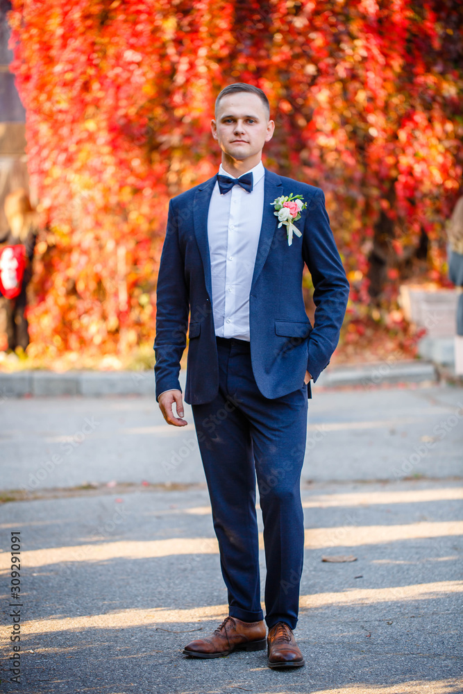 portrait of the groom on a red background portrait of the groom on a red background