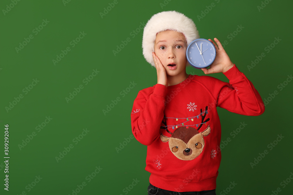 Surprised little boy with alarm clock on color background. Christmas countdown concept Surprised little boy with alarm clock on color background. Christmas countdown concept