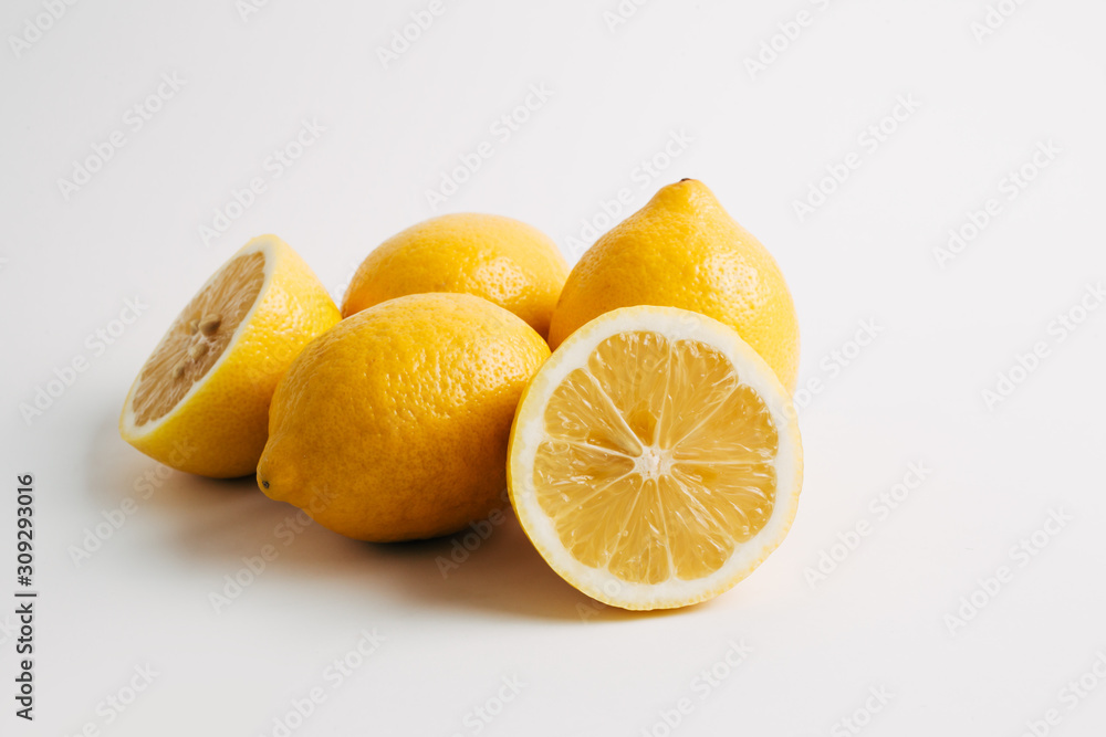 Lemon fruit composition whole fruits and halves stack. Close up, front, detailed image on a clean white background. Lemon fruit composition whole fruits and halves stack. Close up, front, detailed image on a clean white background.